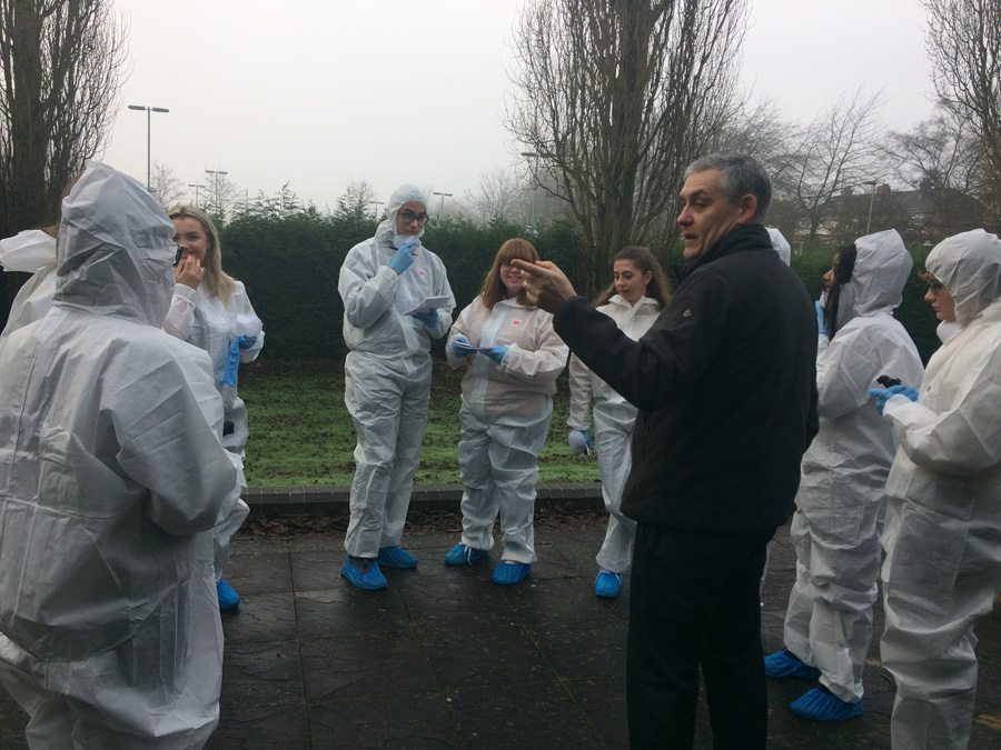 Photo of students investigating the Crime Scene House