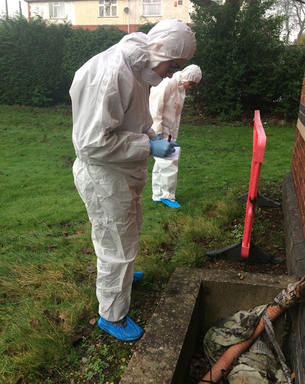 Photo of students investigating the Crime Scene House