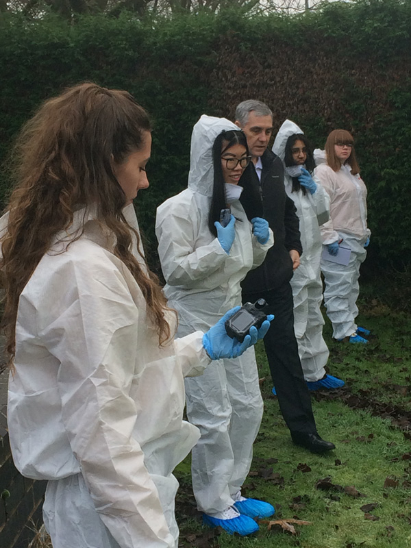 Photo of students investigating the Crime Scene House